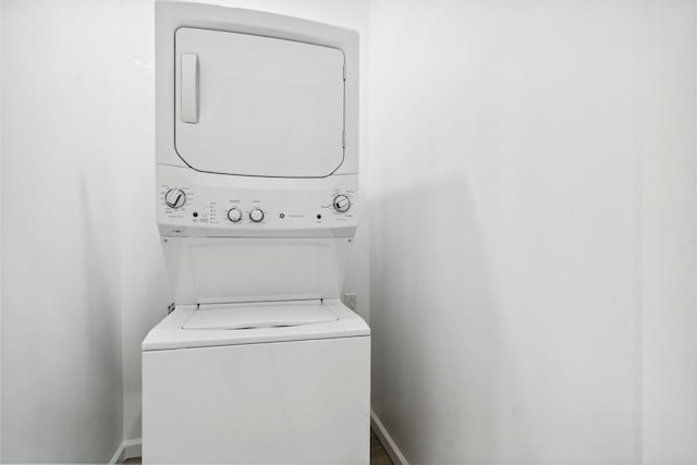 laundry area featuring stacked washing maching and dryer