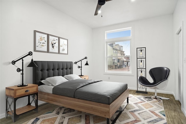 bedroom with ceiling fan and hardwood / wood-style flooring