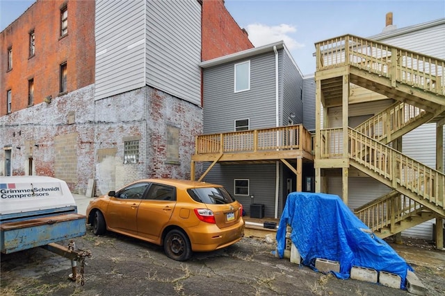 616 S Mathilda St, Bloomfield, PA 15224 - rear view of property featuring stairs, brick siding, and a deck
