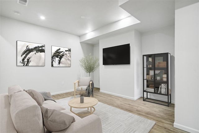 living room with light hardwood / wood-style flooring