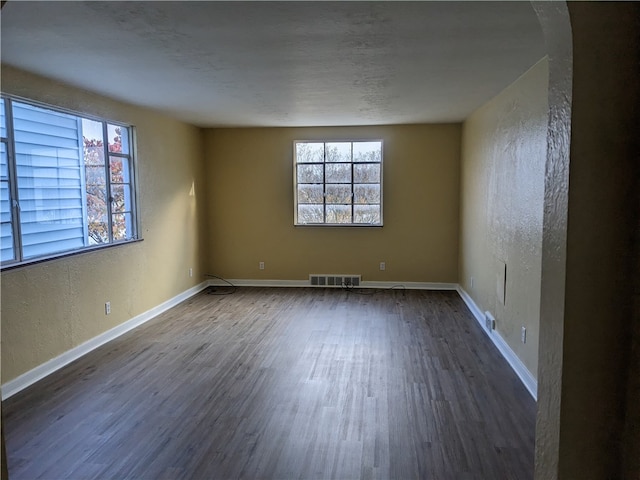 empty room featuring dark wood-type flooring