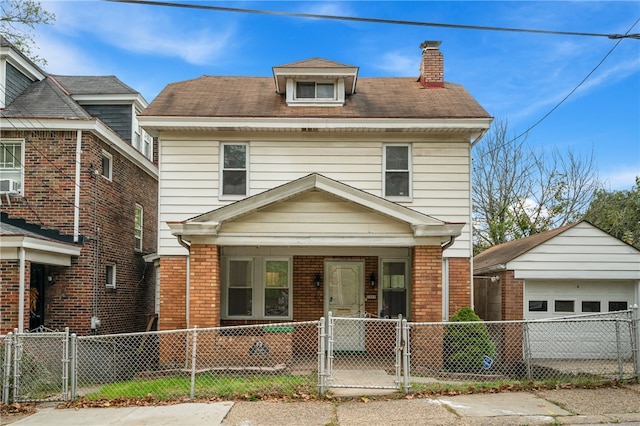 view of front facade with an outbuilding, a porch, and a garage