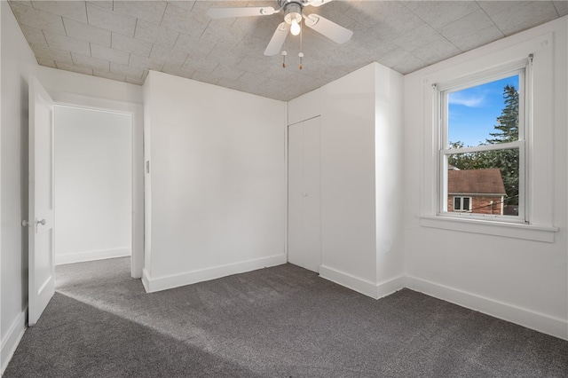 carpeted empty room with ceiling fan