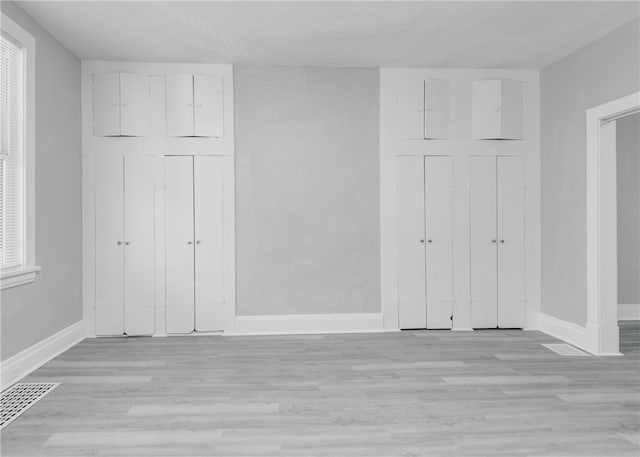 unfurnished bedroom with a closet and light wood-type flooring