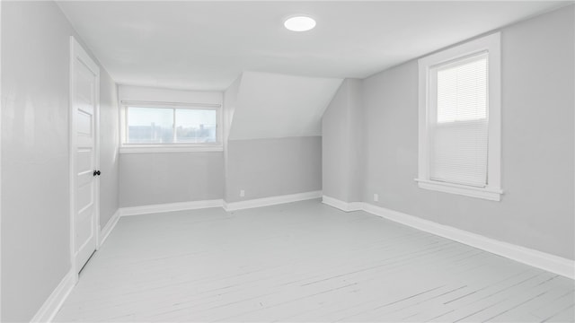 bonus room featuring vaulted ceiling and light hardwood / wood-style floors