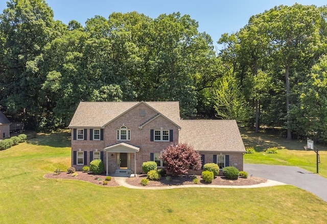 colonial inspired home with a front yard