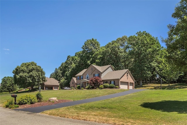 view of front of home featuring a front yard and a garage