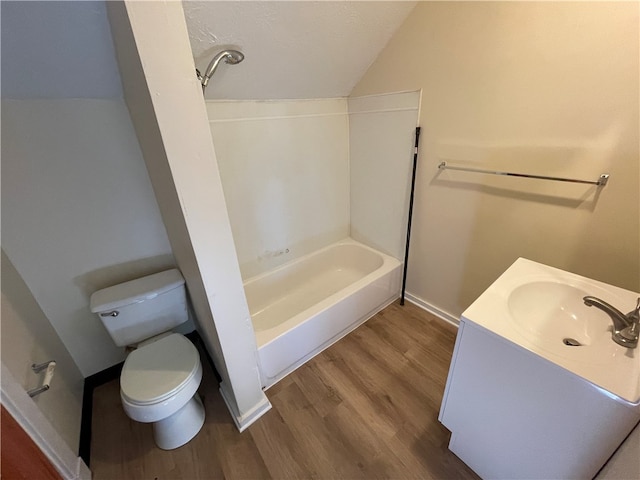 full bathroom with vanity, lofted ceiling, toilet, shower / bathtub combination, and hardwood / wood-style floors