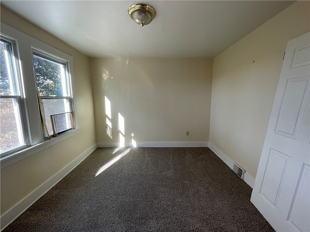 carpeted empty room with plenty of natural light