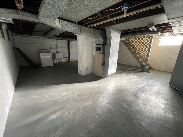 basement featuring sink and washer / dryer