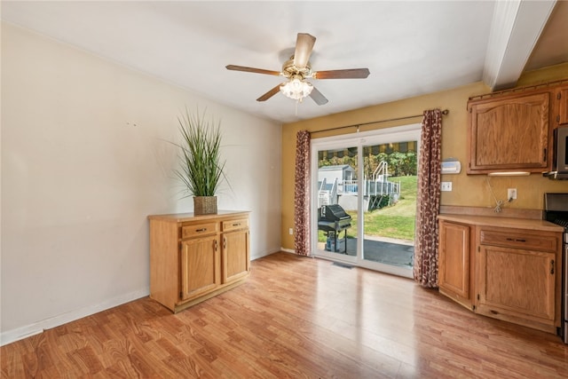 interior space featuring light hardwood / wood-style floors, ceiling fan, and beam ceiling