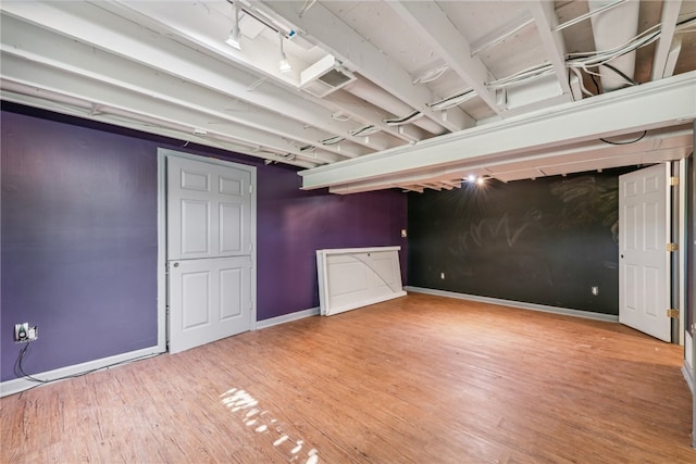 basement featuring hardwood / wood-style flooring