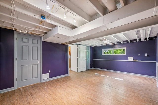 basement with hardwood / wood-style floors