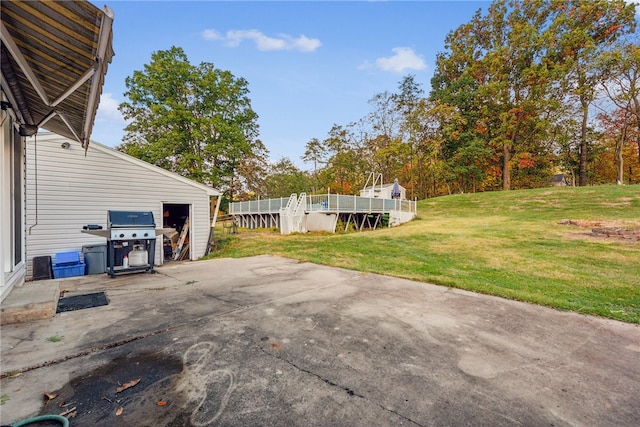 view of yard featuring a wooden deck and a patio