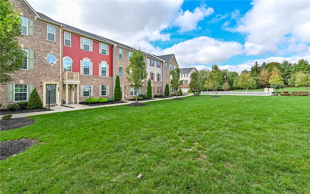 view of yard with a balcony