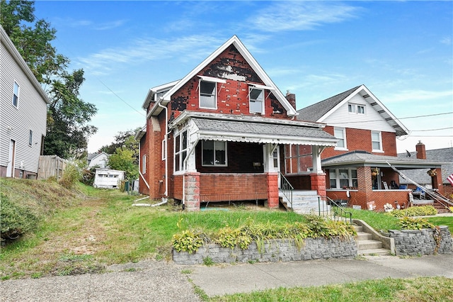 view of front of house with a garage, an outbuilding, and covered porch