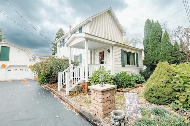 view of front of house featuring covered porch and a garage