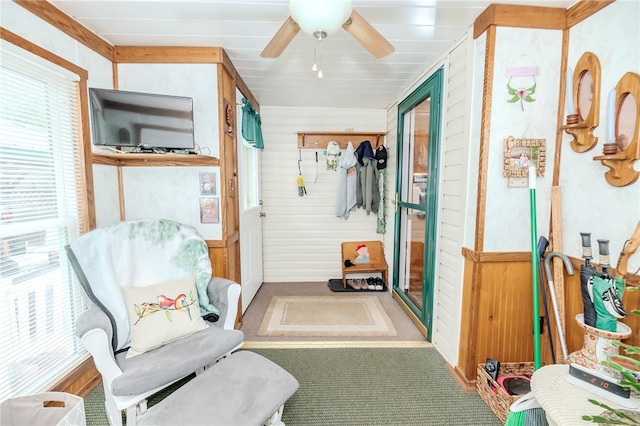 mudroom featuring ceiling fan, carpet floors, and wood walls