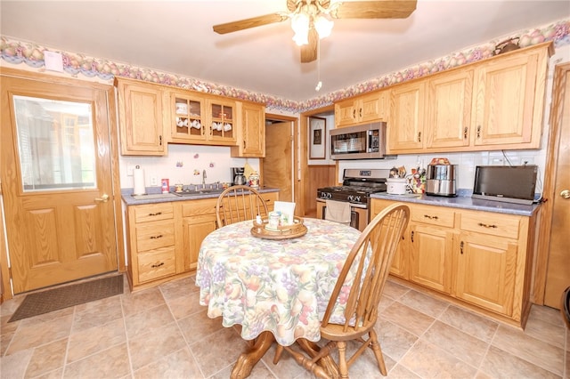 kitchen with ceiling fan, appliances with stainless steel finishes, sink, and light brown cabinets