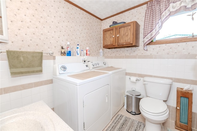 laundry area with crown molding and washer and clothes dryer