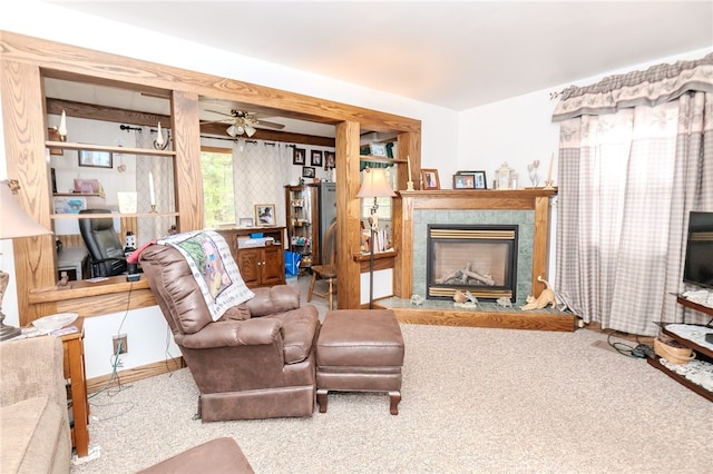 carpeted living room featuring a premium fireplace and ceiling fan