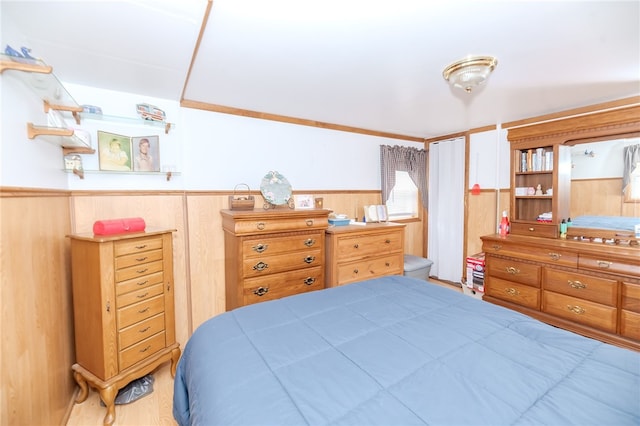 bedroom featuring wood walls and wood-type flooring