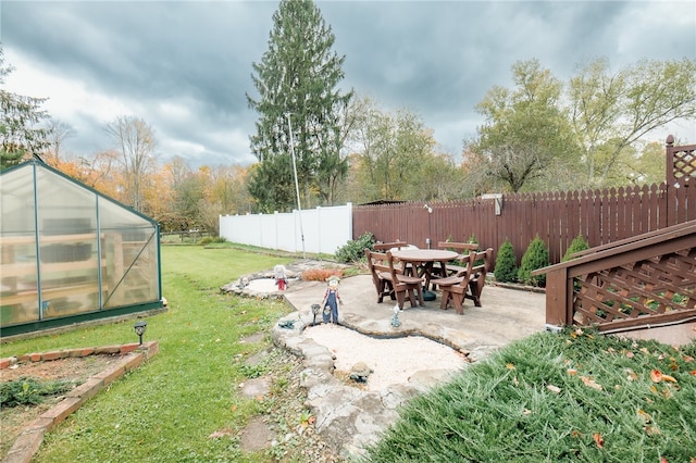 view of yard with a patio area and an outbuilding