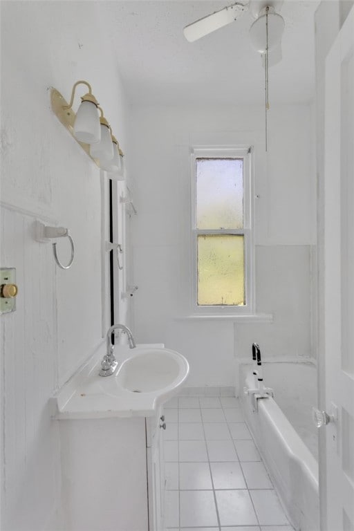 bathroom featuring vanity, bathtub / shower combination, ceiling fan, and tile patterned flooring