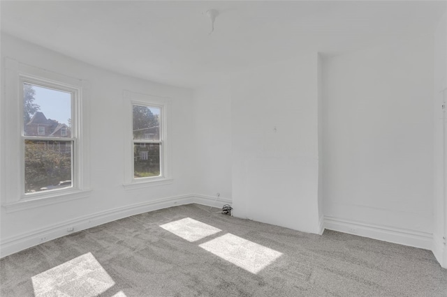 unfurnished room with light colored carpet