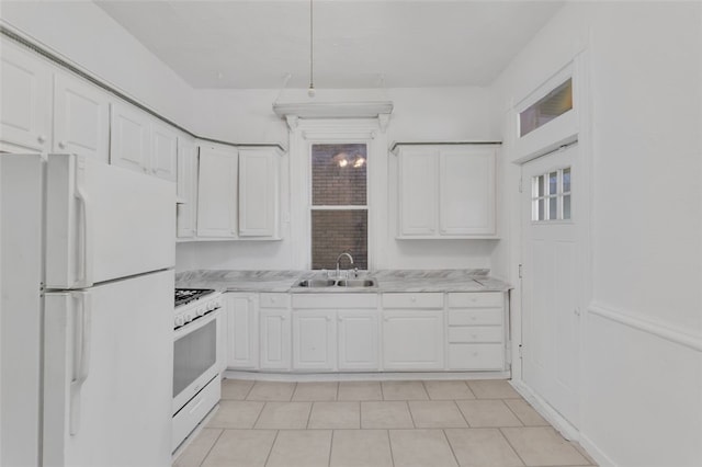 kitchen featuring sink, white cabinetry, white appliances, and light tile patterned floors