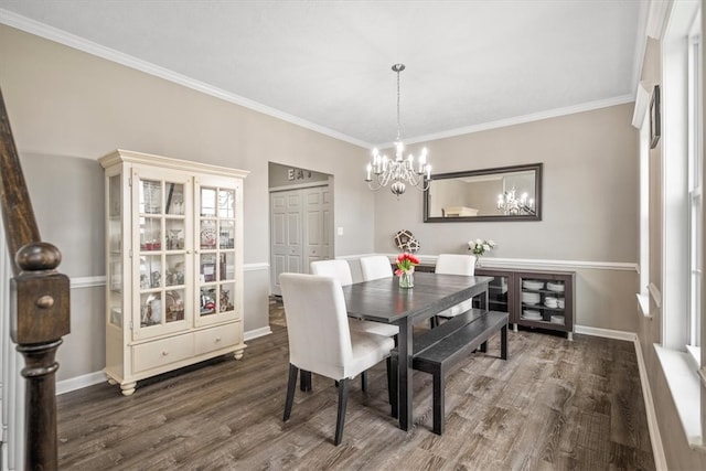 dining area featuring crown molding, a chandelier, and dark wood-type flooring