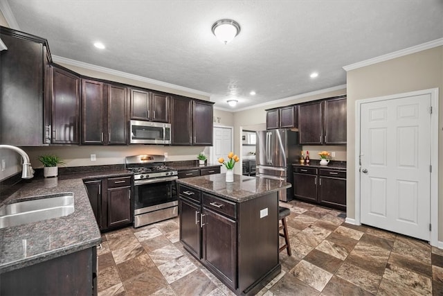 kitchen with a center island, dark brown cabinetry, stainless steel appliances, and sink