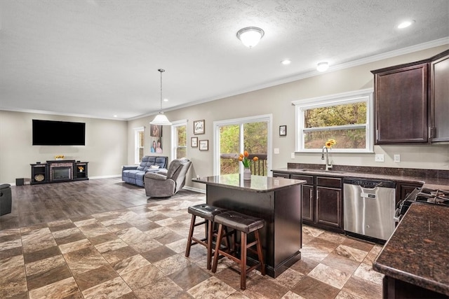 kitchen with dishwasher, a kitchen island, dark brown cabinets, sink, and a breakfast bar