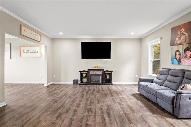 living room with ornamental molding and hardwood / wood-style floors