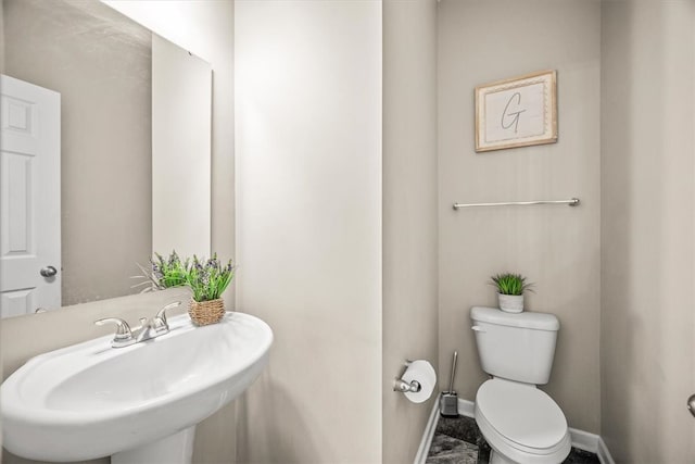 bathroom featuring toilet and sink