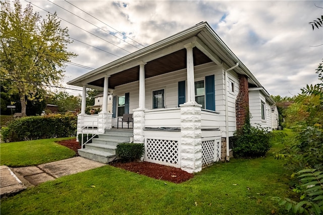 view of front of home with a front lawn and a porch