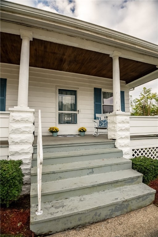 view of exterior entry featuring a porch