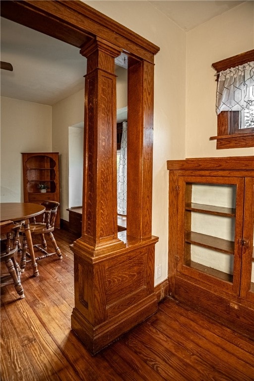 interior details with wood-type flooring and decorative columns