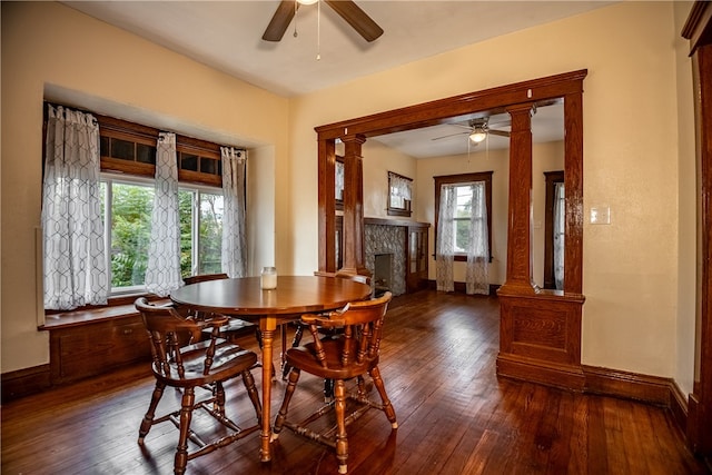 dining area featuring dark hardwood / wood-style floors, ceiling fan, and decorative columns