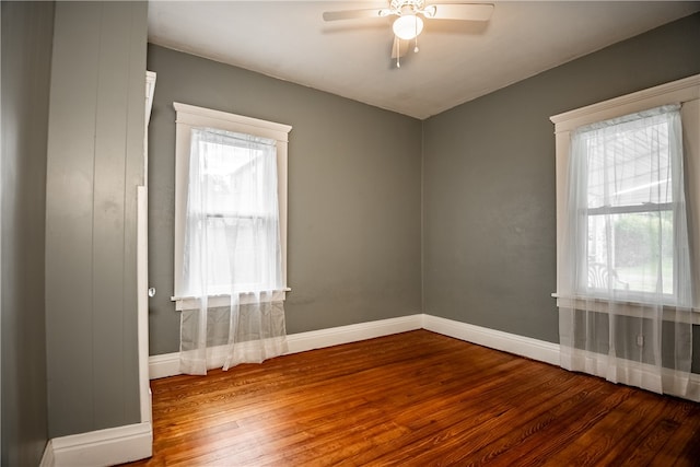 spare room with hardwood / wood-style flooring, plenty of natural light, and ceiling fan