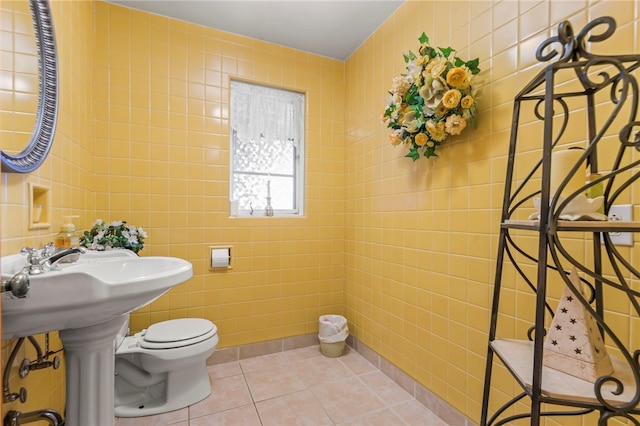 bathroom featuring tile walls, toilet, and tile patterned flooring