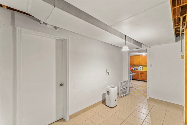 basement featuring light tile patterned floors