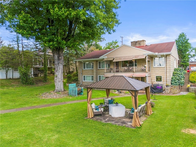 back of house featuring a yard, a gazebo, and a patio area