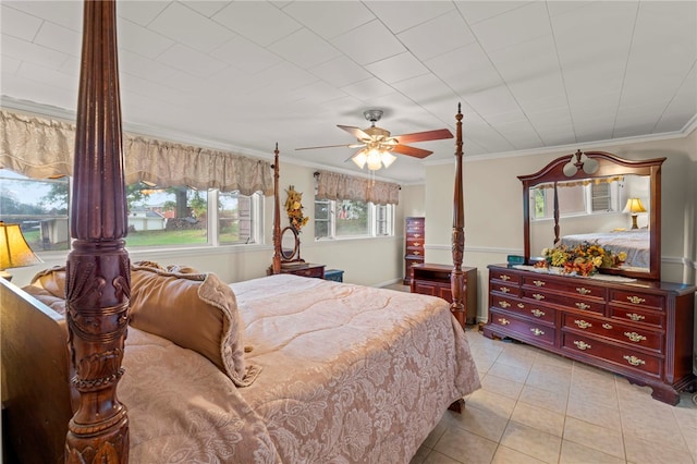 tiled bedroom featuring ceiling fan and ornamental molding