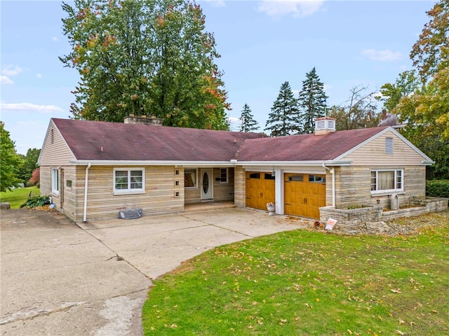 single story home with a front yard and a garage