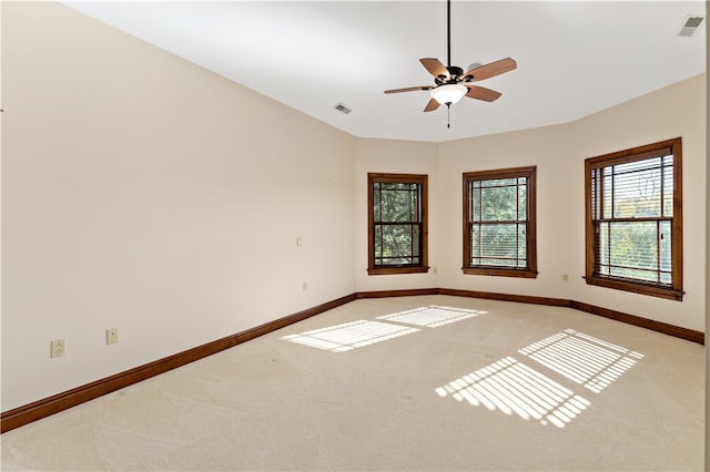 unfurnished room featuring ceiling fan and light colored carpet