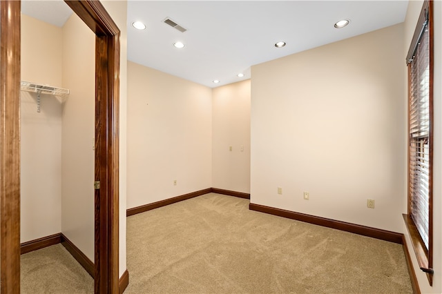 unfurnished bedroom featuring light carpet