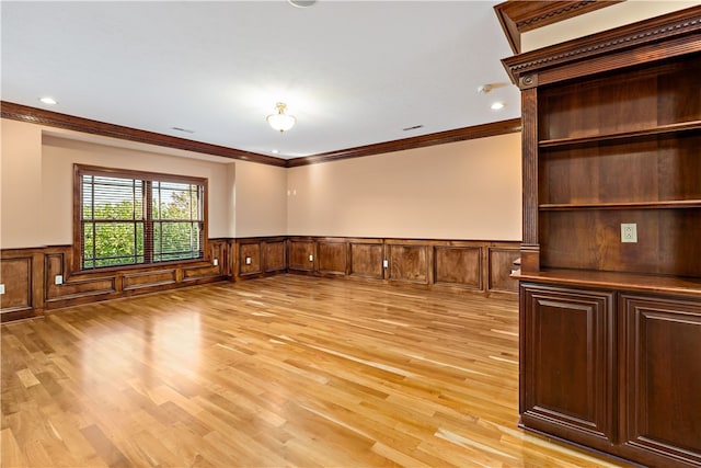 interior space with crown molding and light hardwood / wood-style floors