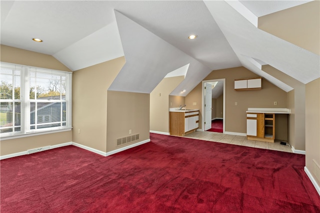 additional living space with lofted ceiling and light carpet