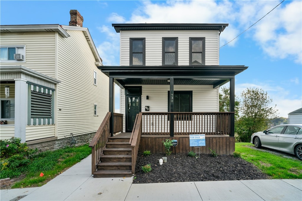 view of front facade featuring covered porch and cooling unit